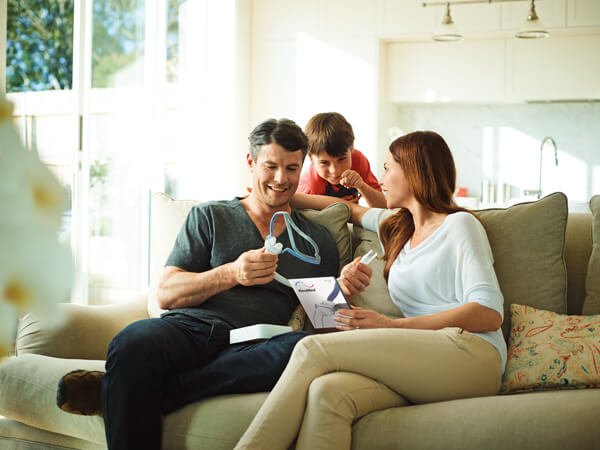 family gathered around a cpap mask