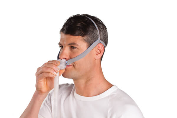 CPAP nasal mask nose fitting on the face.