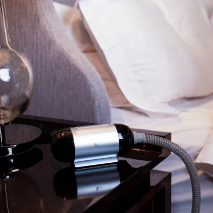 BMC M1 Mini Automatic Travel CPAP Device on patient table at home